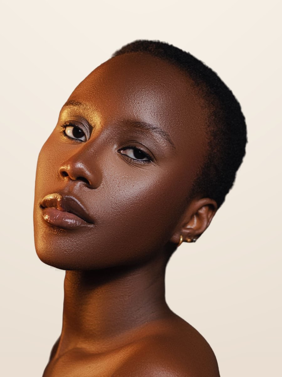 Model with a deep skin tone and radiant, healthy skin