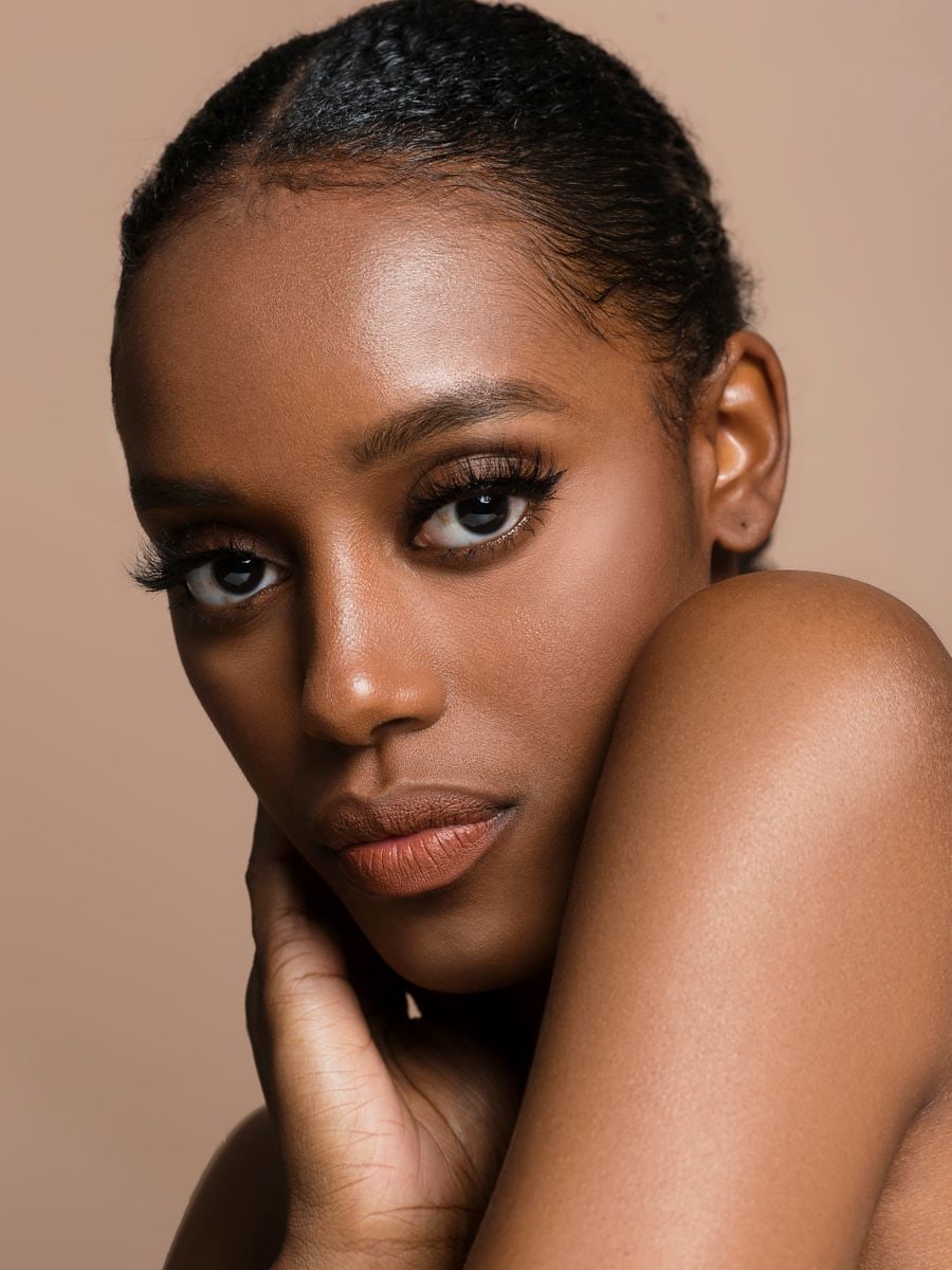 Model with deep skin and luminous, healthy skin
