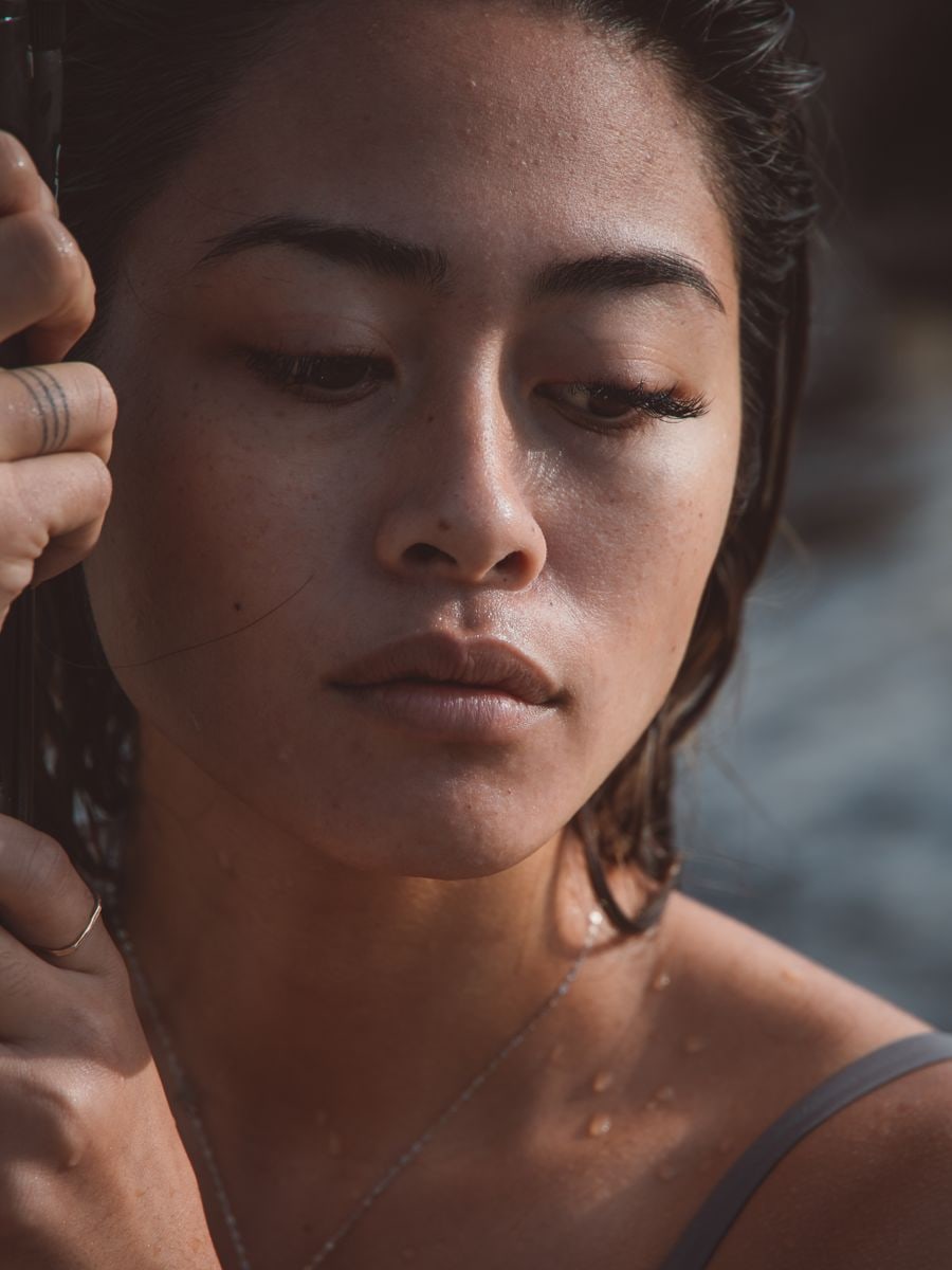 Model with a warm olive complexion and glowing skin